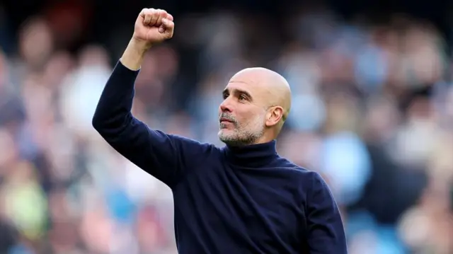 Pep Guardiola fist pumping the crowd