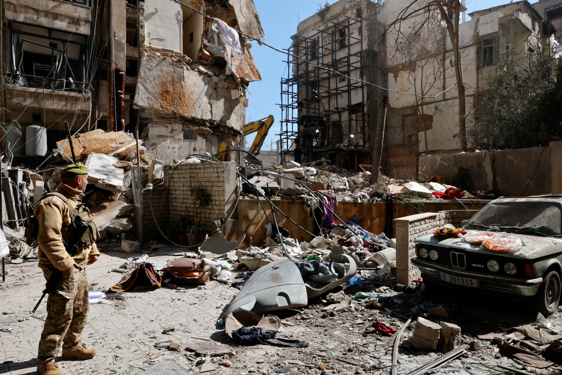 A Lebanese soldier stands next to a destroyed residential building and rubble from an Israeli airstrike in Beirut, Lebanon.