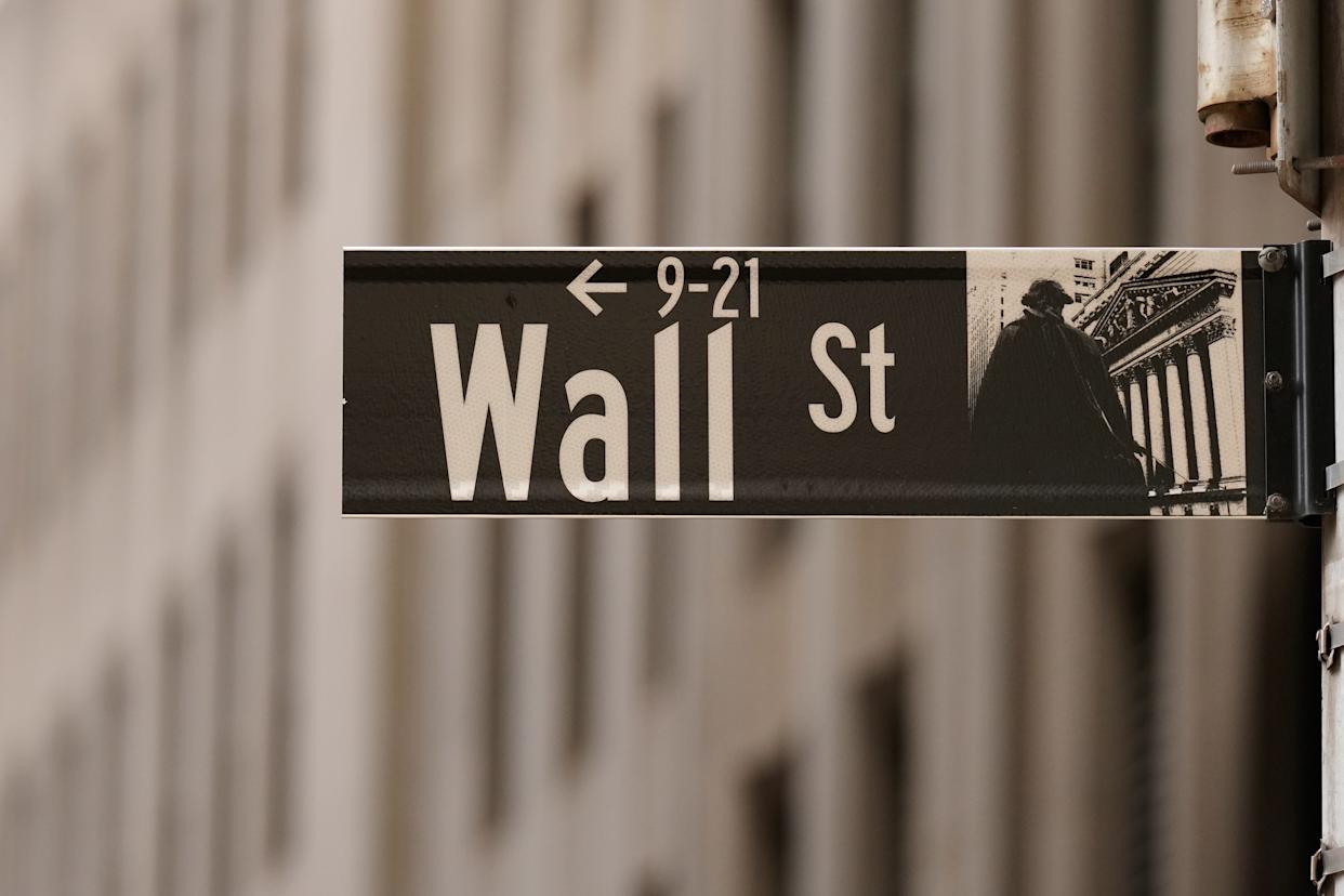 A Wall Street sign is seen outside of the New York Stock Exchange in New York, Monday, March 30, 2026. (AP Photo/Seth Wenig)