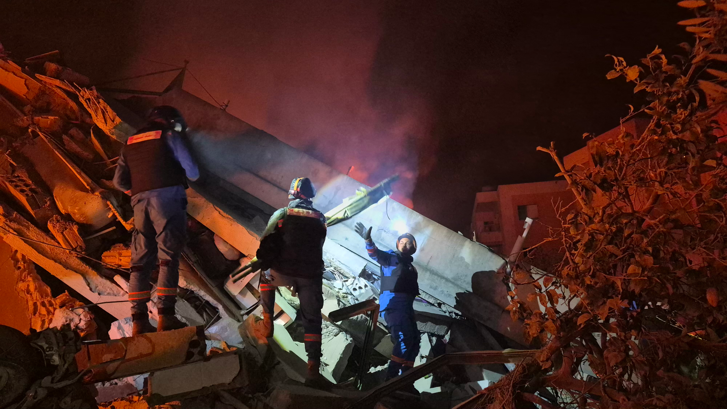 First responders search through rubble at night after an Israeli airstrike in Habbouch, southern Lebanon.