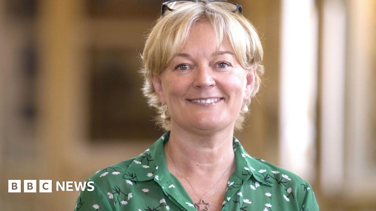 Jo Malone wearing green patterned dress and necklace with a star pendant
