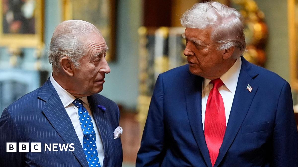 King Charles and President Trump during the state visit in September. They are talking to each other, both wearing blue suits and ties