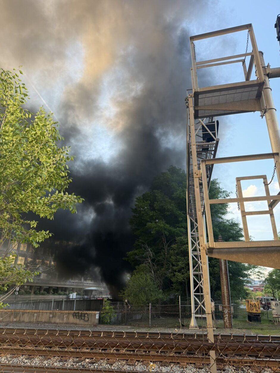 smoke fills the sky in city