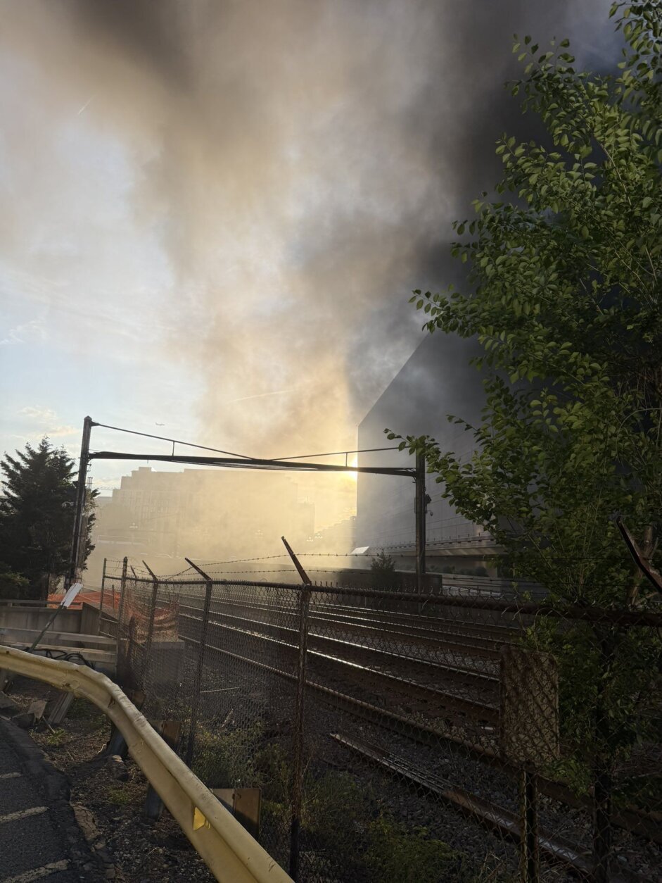 smoke fills the sky in city