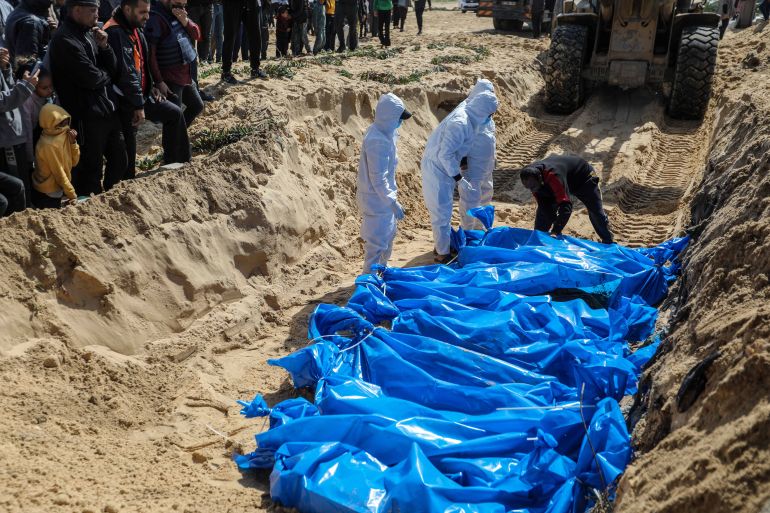 RAFAH, GAZA - MARCH 7: (Editor's Note: Image depicts death) The bodies of Palestinians killed during the war were buried in a mass grave and the Gaza Ministry of Health said 47 bodies were confiscated by Israeli forces and delivered through the Israeli-controlled Kerem Shalom crossing on March 7, 2024 in Rafah, Gaza. Negotiations being held in Cairo over a potential ceasefire deal appear to have stalled, as the current war between Israel and Hamas reaches the five-month mark. More than 30,000 people have died in Gaza as a result of the war, according to the Hamas-run health ministry. The Israeli government says that between 100 and 130 hostages remain captive in Gaza, after being kidnapped by Hamas militants in a surprise Oct. 7 attack that left around 1,200 dead in Israel. (Photo by Ahmad Hasaballah/Getty Images)