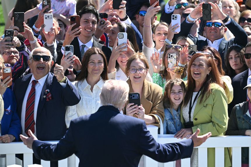 President Donald Trump greets the crowd during the annual Easter Egg Roll on Monday.