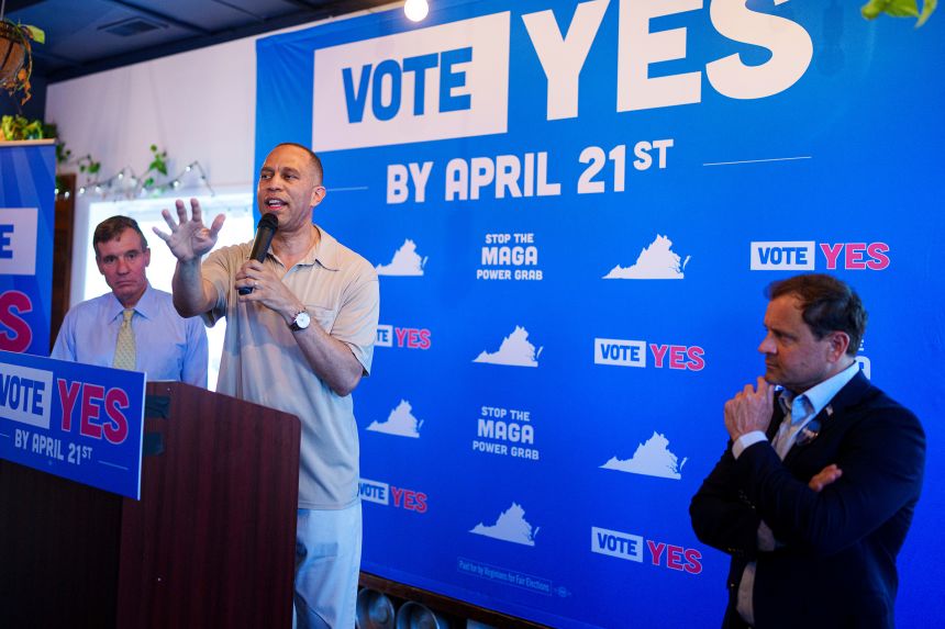 House Minority Leader Hakeem Jeffries, center, flanked by Sen. Mark Warner and Congressional candidate Tom Perriello, speaks at the Virginians for Fair Elections rally in Charlottesville, Virginia, on April 11.
