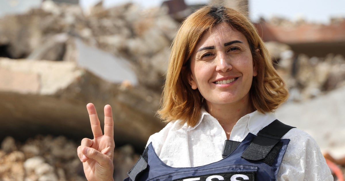 Amal Khalil, a veteran correspondent for the daily newspaper Al-Akhbar, is seen in the southern Lebanese border village of Jebbayn in 2024.