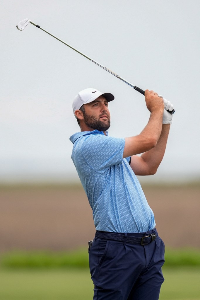 Scottie Scheffler watches his ball travel to the 18th green during the final round of the RBC Heritage golf tournament. 