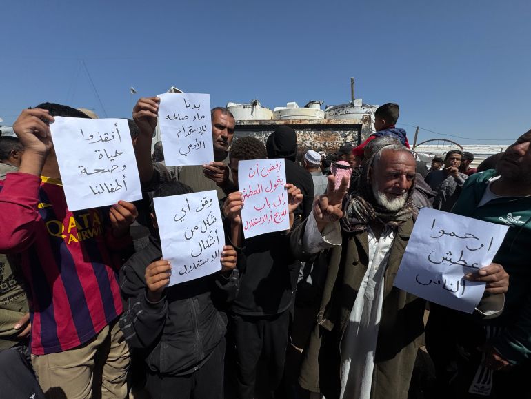 Protesters carry paper with slogans