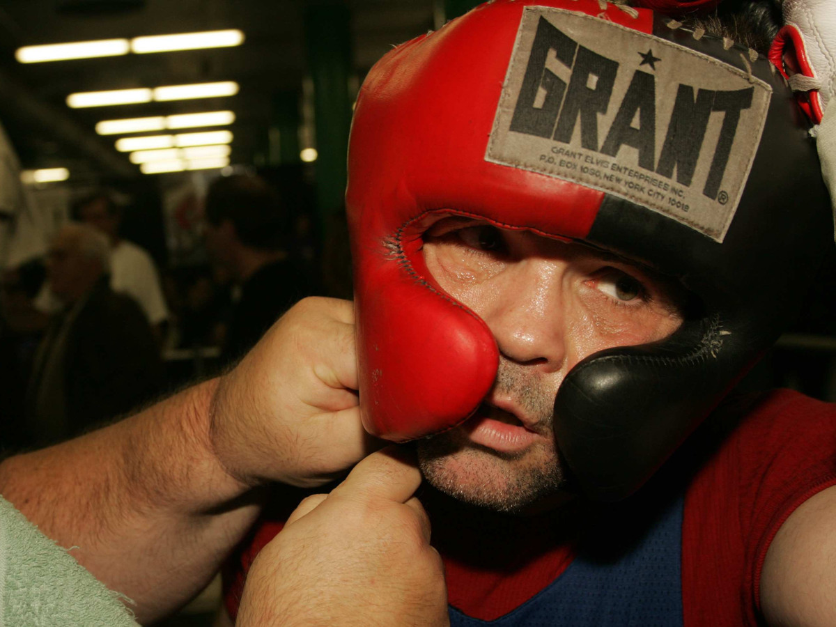 Alex Hilton has his boxing headgear adjusted.