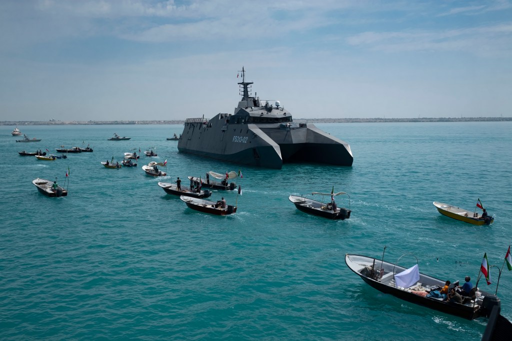 The Islamic Revolutionary Guard Corps Navy's Martyr Hassan Bagheri warship leading Basij paramilitary force speed boats in the Persian Gulf.