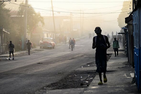 Cubans walk along a street in Havana