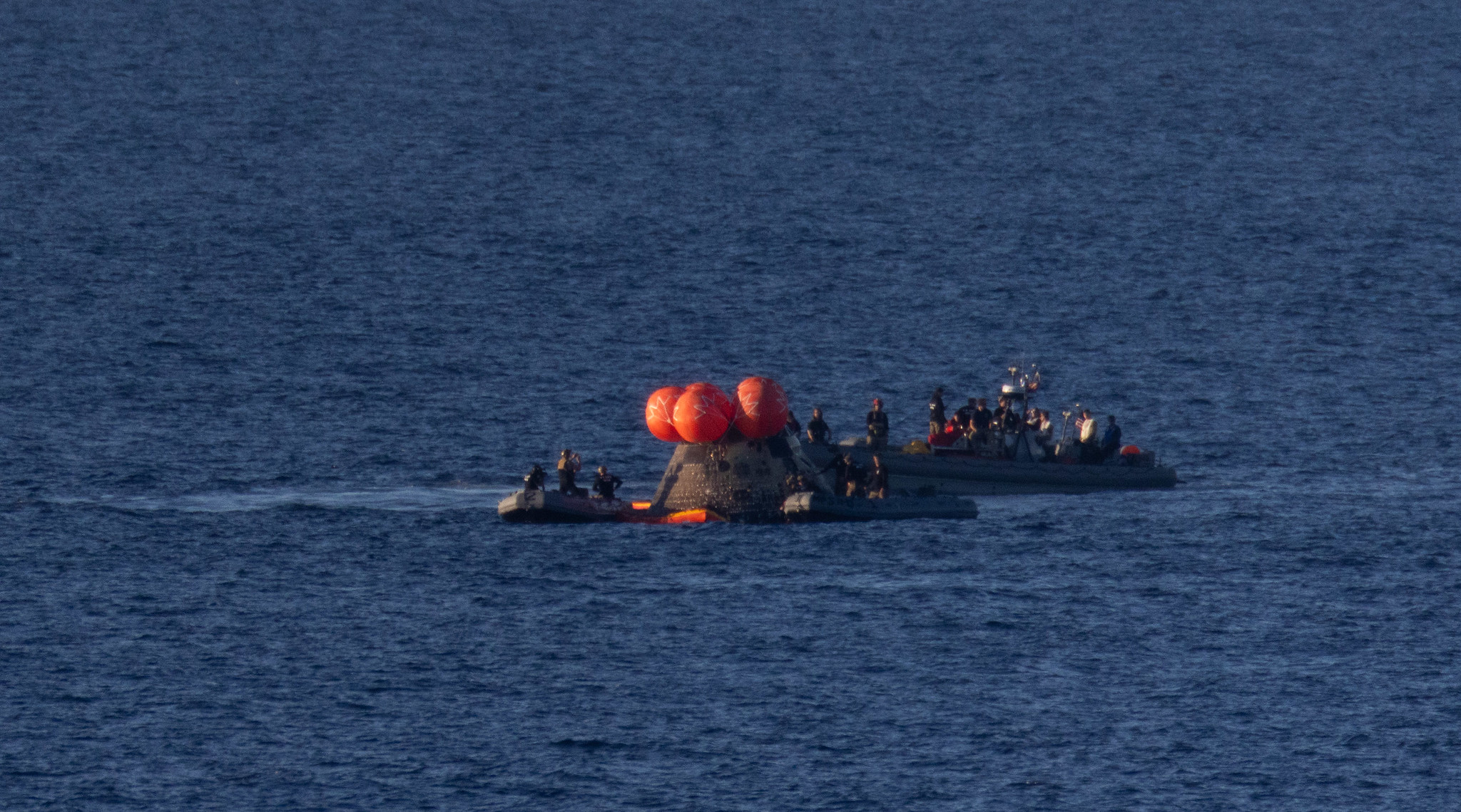 NASA’s Orion spacecraft is seen as recovery teams work to secure the spacecraft ahead of transferring Artemis II crewmembers.
