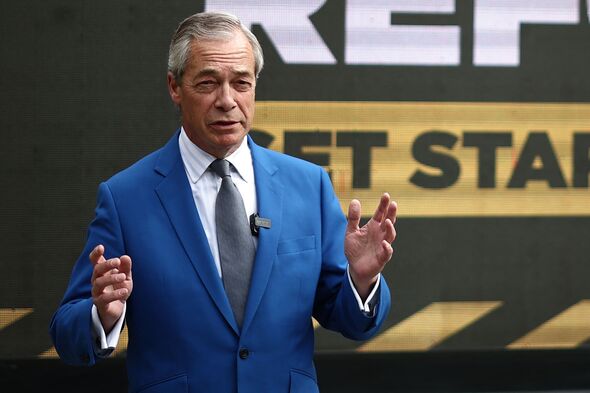 Nigel Farage speaking and wearing a blue suit Nigel Farage speaking and wearing a blue suit