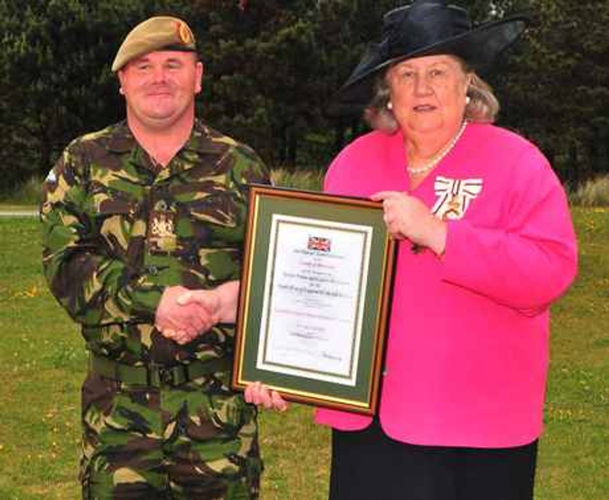 Regimental Sergeant Major Instructor Stephen Finnigan receiving his award from HM Lord-Lieutenant of Merseyside, Colonel Dame Lorna Muirhead