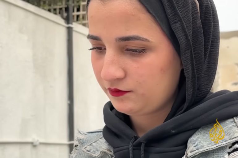 Mona Al-Mashharawi was scheduled to travel to Algeria for her university studies, but the war and sealed borders have kept her trapped in Gaza for over two years. [Screengrab/Al Jazeera]