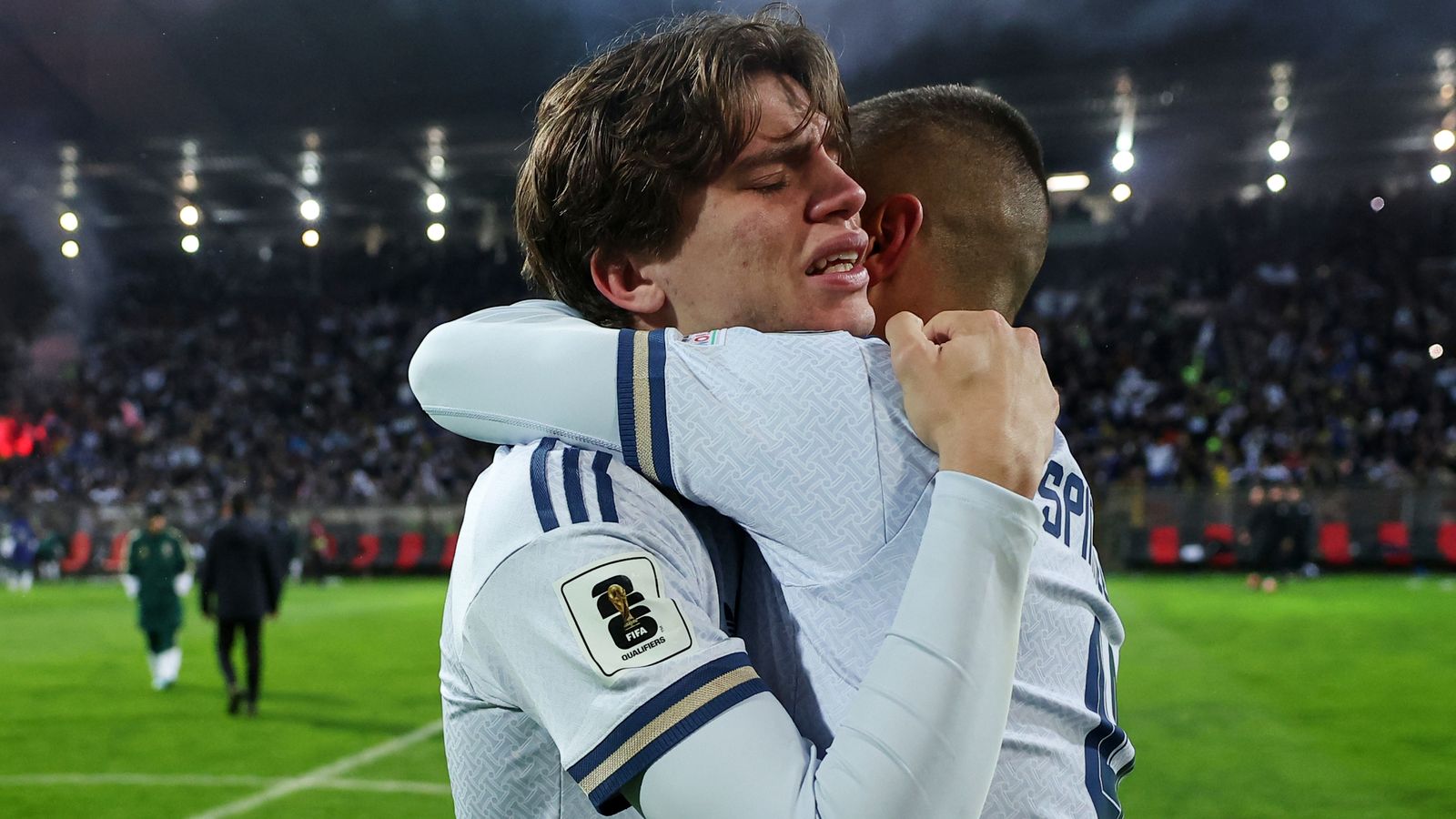 Italy's Marco Palestra, left, and Leonardo Spinazzola console each other after losing a penalty shootout during the World Cup qualifying playoff final soccer match between Bosnia and Italy in Zenica, Bosnia, Tuesday, March 31, 2026. (AP Photo/Armin Durgut)
