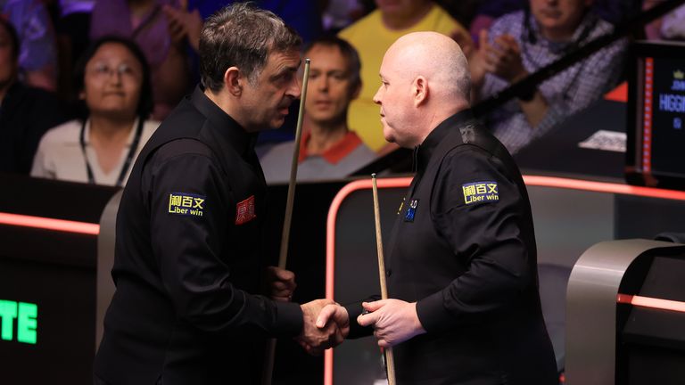O'Sullivan and Higgins shake hands after their match