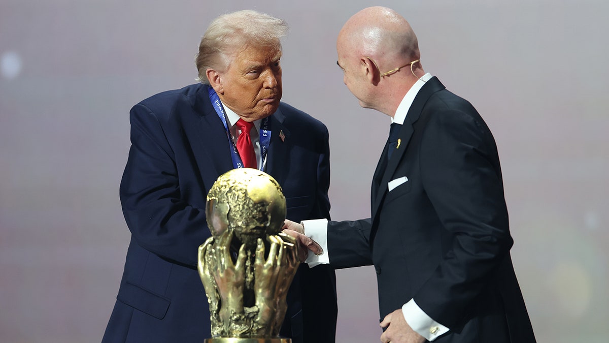 President Donald Trump receiving the FIFA Peace Prize from FIFA President Gianni Infantino at the John F. Kennedy Center in Washington, D.C.