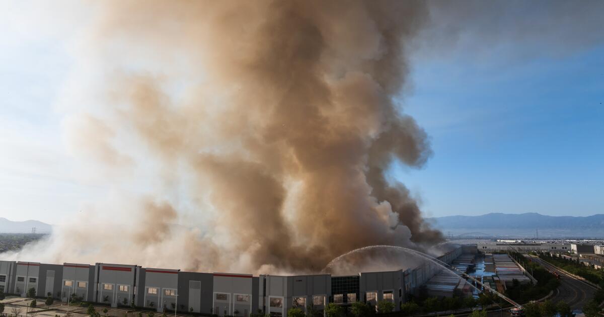 Roof collapses, firefighters retreat as massive paper warehouse goes up in flames