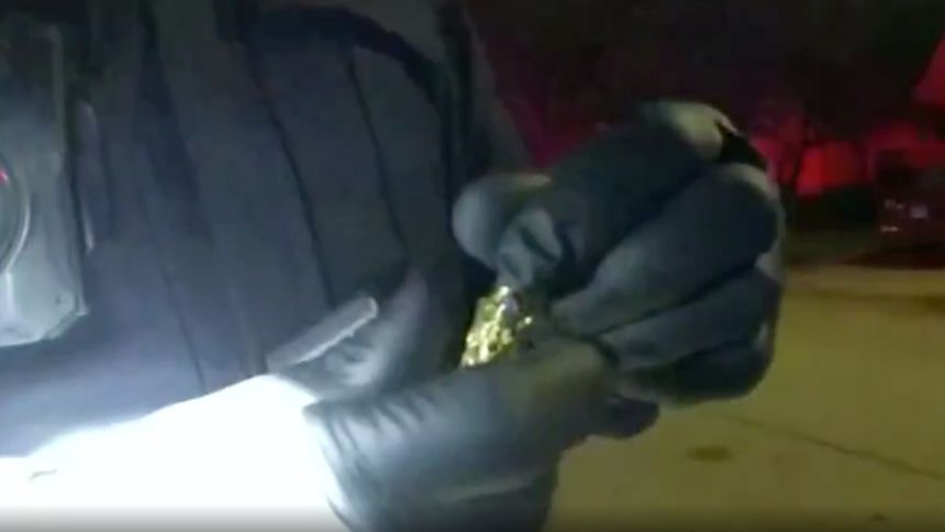 A Springfield police officer holds the small urn that contained the ashes of Dartavius Barnes' daughter.