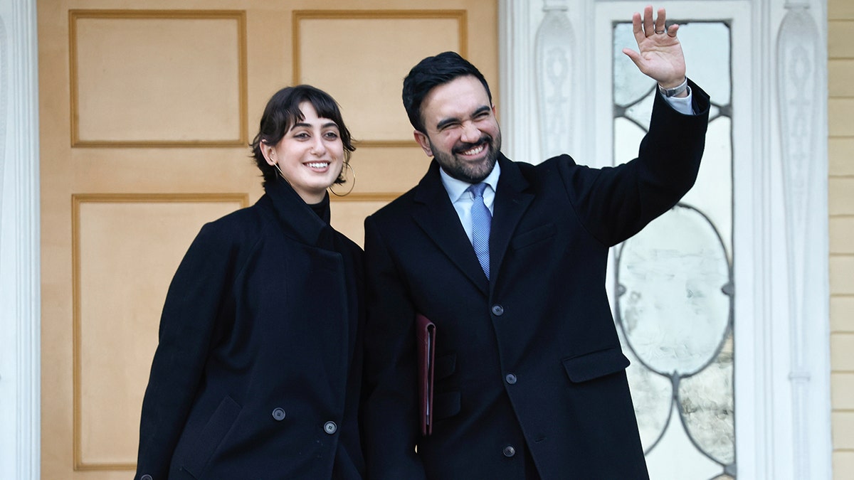 Zohran Mamdani and his wife Rama Duwaji standing at Gracie Mansion during a news conference