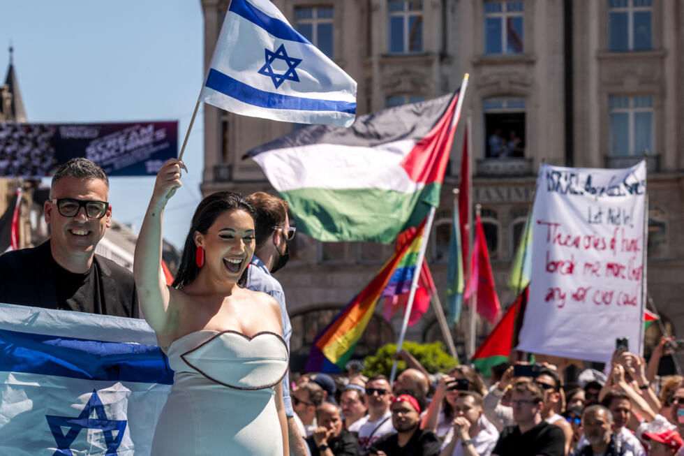 Israeli singer Yuval Raphael arrives at the Eurovision opening ceremony as protesters wave Palestinian flags in Basel, Switzerland, on May 11, 2025