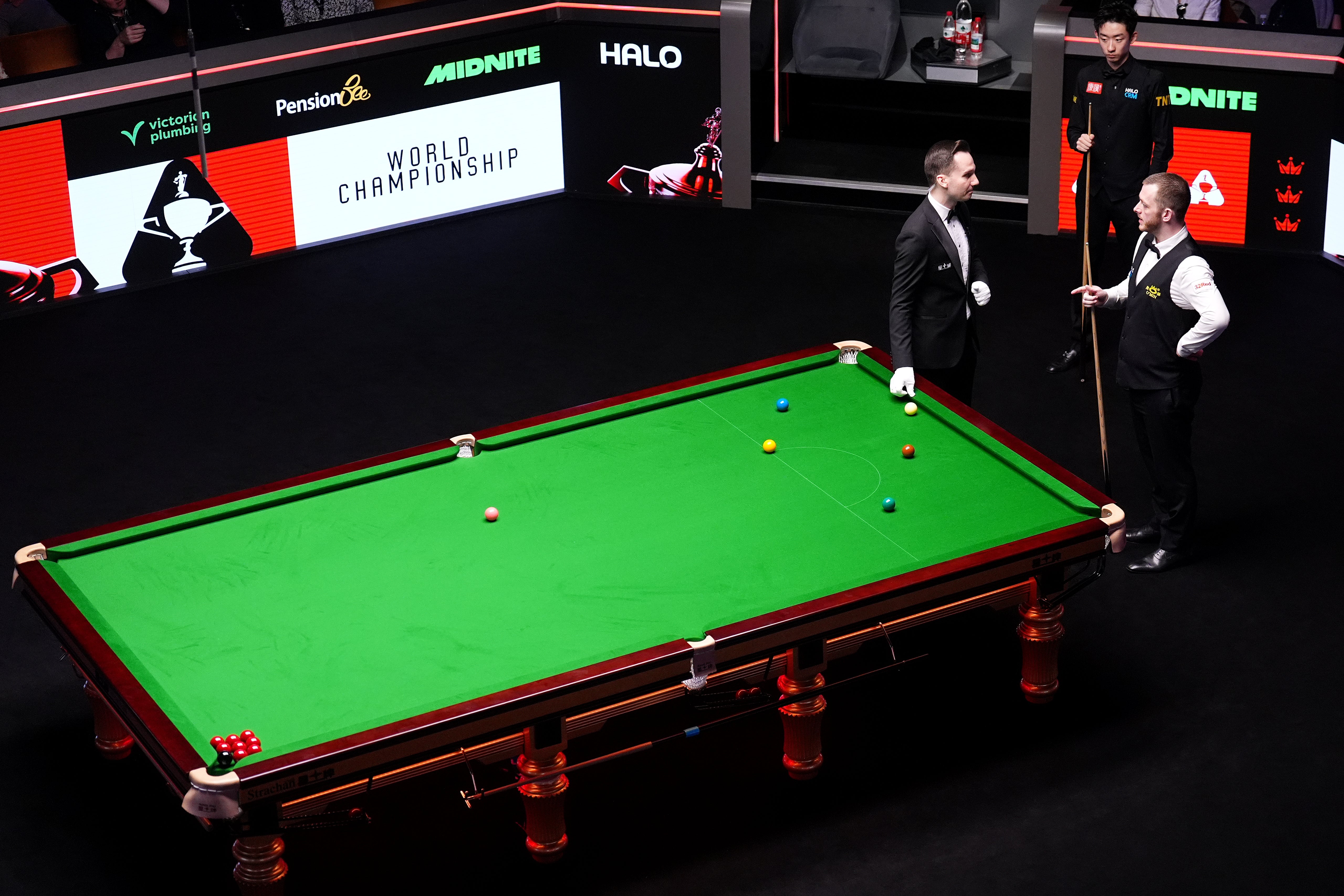 The referee discusses the situation with Mark Allen