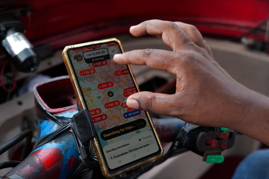 A hand searches on a phone displaying delivery orders 