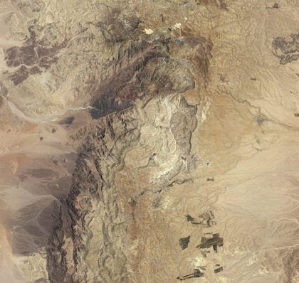 Khirbet en-Nahas: Black piles of slag define this ancient copper mining and smelting site. The faint square on the northern edge of the site is an Iron Age fortress. Credit: NASA Earth Observatory, Robert Simmon Khirbet en-Nahas: Black piles of slag define this ancient copper mining and smelting site. The faint square on the northern edge of the site is an Iron Age fortress.