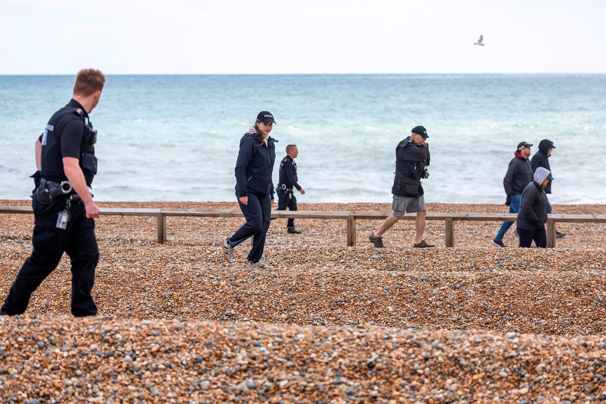 Police officers searched along Brighton beach in a bid to find the women's belongings