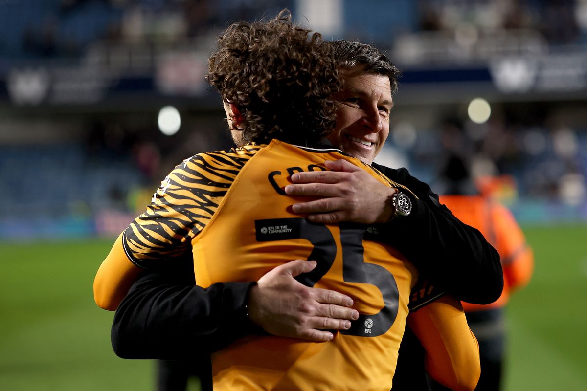 Matt Crooks and Sergej Jakirovic embrace at The Den
