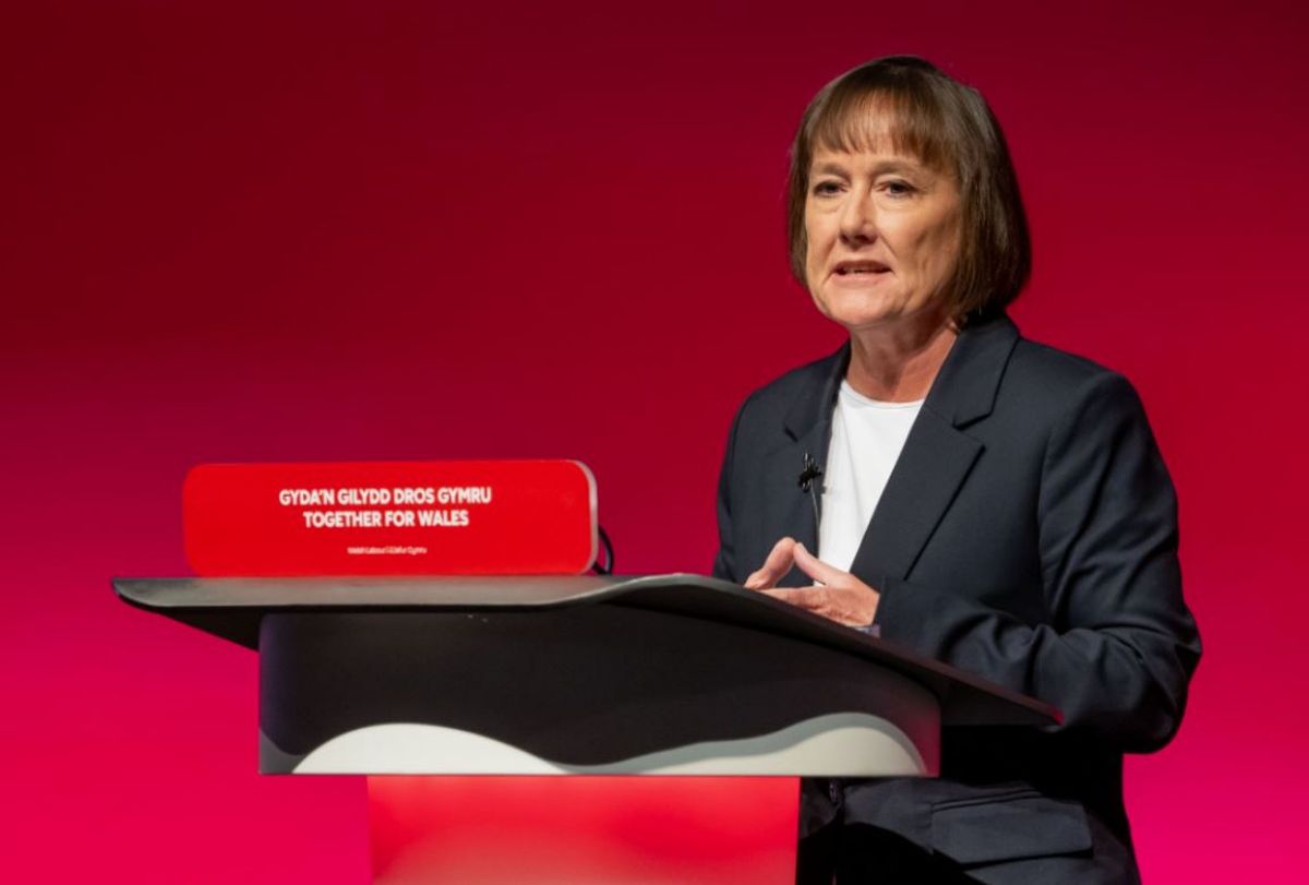 A woman speaking at a lectern 