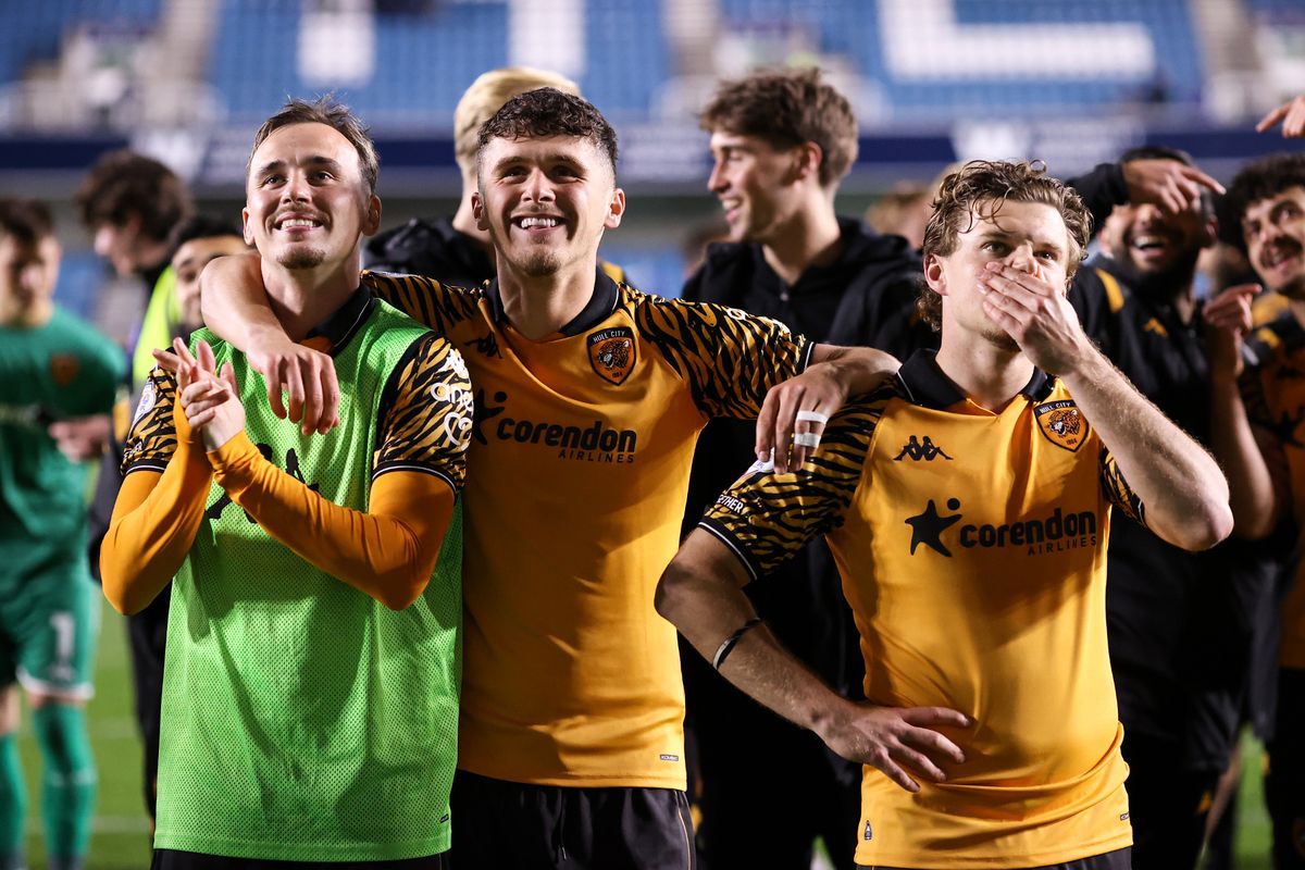 Liam Millar, Ryan Giles and Regan Slater of Hull City stand to take in the moment while celebrating during the Sky Bet Championship Play Off Semi Final Second Leg match between Millwall and Hull City. 