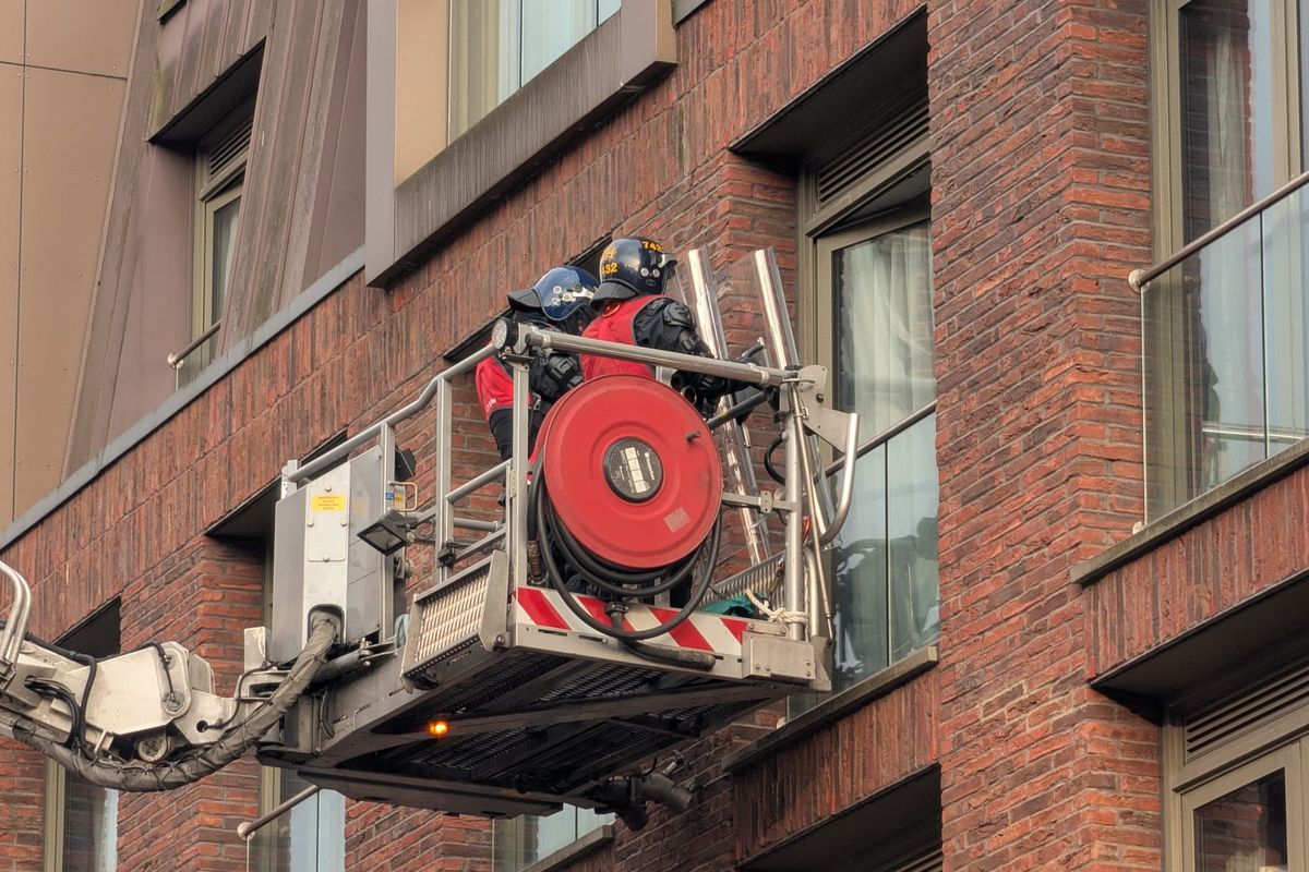 Riot police on a cherry picker outside the Ropewalks Hotel