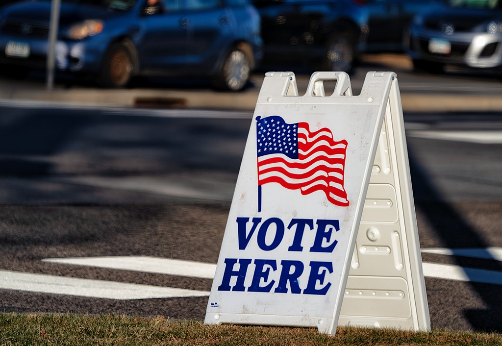 What makes issues matter at the ballot box? Photo shows a "vote here" sign board.