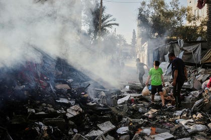 Palestinians walk through the rubble of the Al-Kurd family home, destroyed in an Israeli airstrike in Deir al-Balah, central Gaza Strip, Sunday. Credit: Abdel Kareem Hana/AP Palestinians walk through the rubble of the Al-Kurd family home, destroyed in an Israeli airstrike in Deir al-Balah, central Gaza Strip, Sunday.
