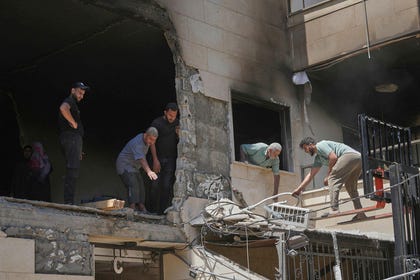 Residents and workers clear debris from an apartment building damaged in an Israeli airstrike a day earlier in Choueifat, in Dahiyeh, Beirut's southern suburbs, Lebanon, Friday. Credit: Hassan Ammar/AP Residents and workers clear debris from an apartment building damaged in an Israeli airstrike a day earlier in Choueifat, in Dahiyeh, Beirut's southern suburbs, Lebanon, Friday.