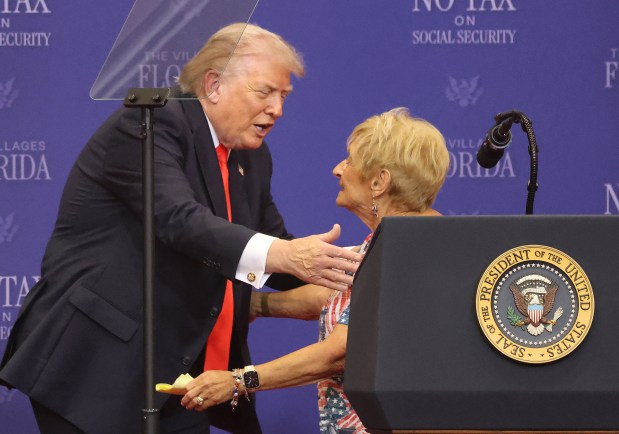 President Donald Trump thanks a Villages resident on stage for her support during his visit at The Villages High School, Friday, May 1, 2026. (Joe Burbank/Orlando Sentinel)