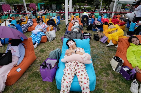 Participants take a nap during the 2026 Hangang Nap Competition at Yeouido Hangang Park in Seoul, South Korea, Saturday, May 2, 2026. (AP Photo/Ahn Young-joon)