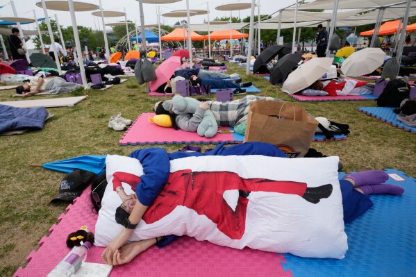 Participants take a nap during the 2026 Hangang Nap Competition at Yeouido Hangang Park in Seoul, South Korea, Saturday, May 2, 2026. (AP Photo/Ahn Young-joon)