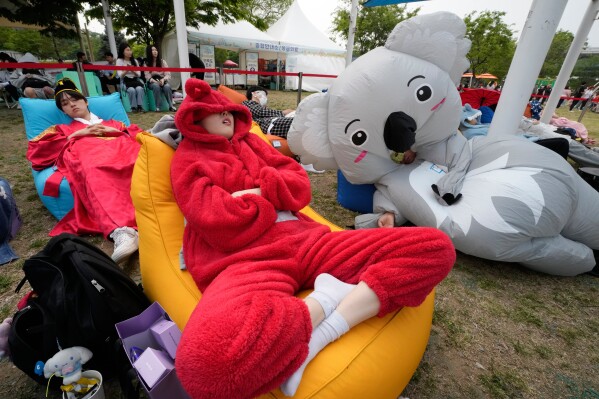 Participants take a nap during the 2026 Hangang Nap Competition at Yeouido Hangang Park in Seoul, South Korea, Saturday, May 2, 2026. (AP Photo/Ahn Young-joon)