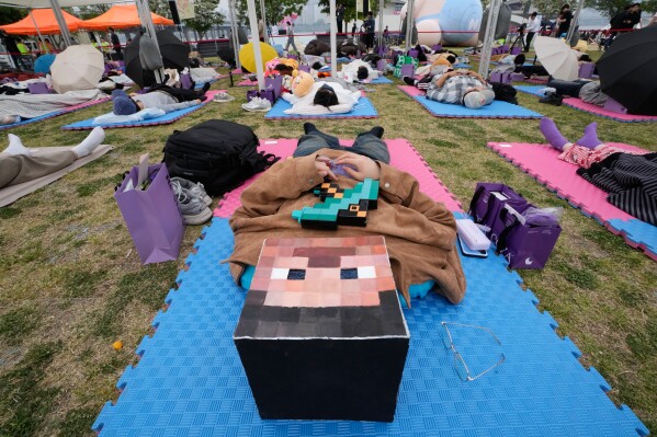 A participant takes a nap during the 2026 Hangang Nap Competition at Yeouido Hangang Park in Seoul, South Korea, Saturday, May 2, 2026. (AP Photo/Ahn Young-joon)