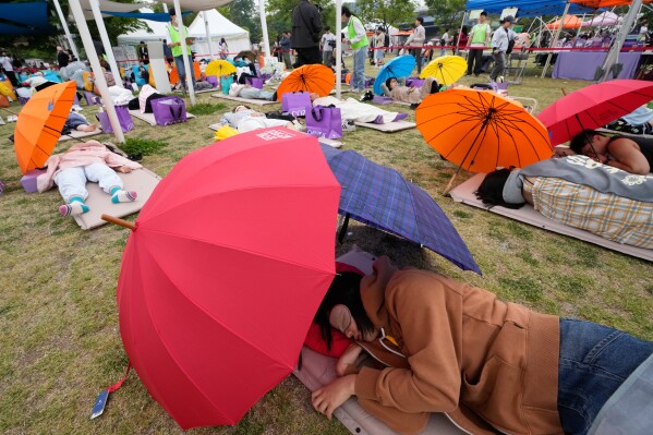 Participants take a nap during the 2026 Hangang Nap Competition at Yeouido Hangang Park in Seoul, South Korea, Saturday, May 2, 2026. (AP Photo/Ahn Young-joon)