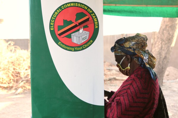 A woman is seen in a voting booth at a polling station in Lusaka, Zambia, Aug, 12, 2021. (AP Photo/Tsvangirayi Mukwazhi, File)