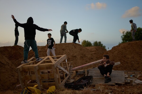 Children collect wood for a a bonfire during Lag BaOmer celebrations in Netanya, Israel, Monday, May 4, 2026. (AP Photo/Ariel Schalit)