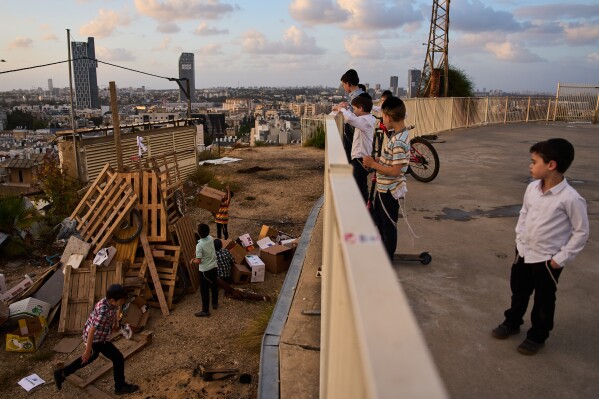 Ultra-Orthodox Jewish children build bonfires in preparation for Lag BaOmer, a Jewish holiday traditionally marked by bonfire, music, and communal celebrations, in Bnei Brak, Israel, Monday, May 4, 2026. (AP Photo/Oded Balilty)