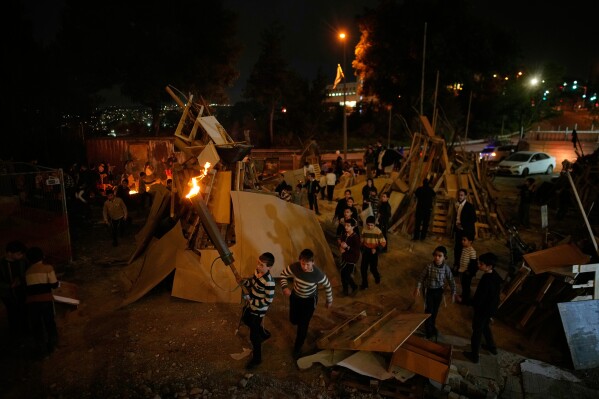 Ultra-Orthodox Jewish boys prepare to light a bonfire during Lag BaOmer, a holiday traditionally celebrated with bonfires, music, and gatherings in Jerusalem, Monday, May 4, 2026. (AP Photo/Ohad Zwigenberg)