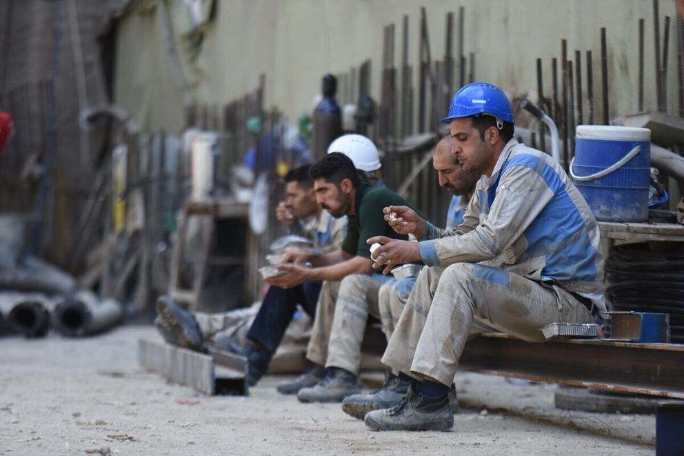 File photo: Construction workers take a break at a site in Iran